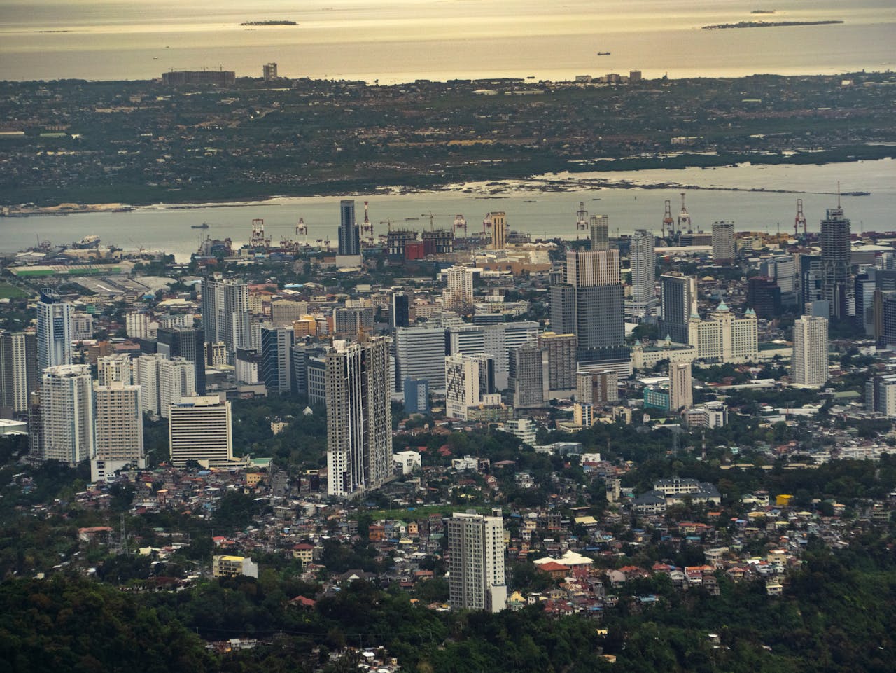 Panoramic view of Cebu City showcasing high-rise buildings and urban landscape with waterfront.