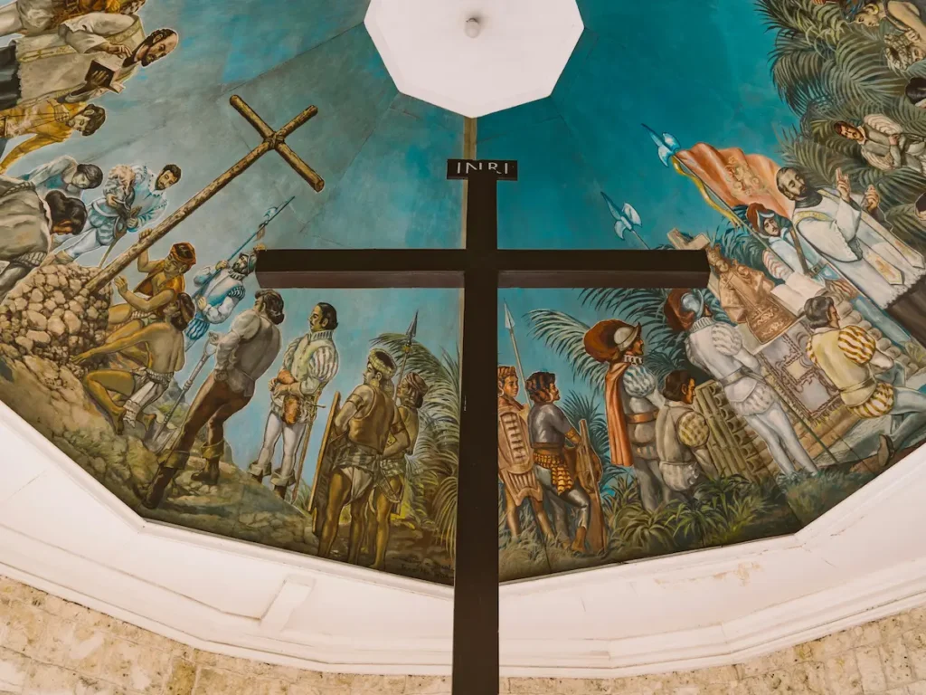 The historic Magellan's Cross with the famous painted ceiling mural depicting the arrival of Spanish colonizers in Cebu City.