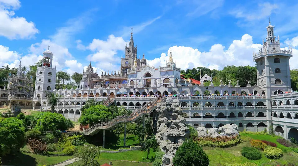 The grand castle like stone architecture and soaring white spires of Simala Shrine in Sibonga Cebu