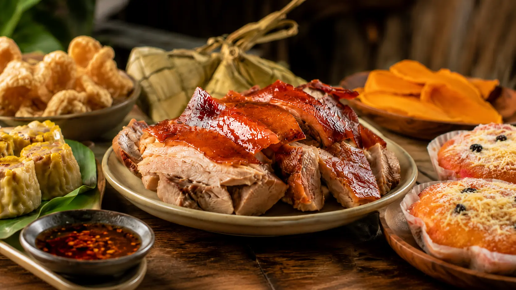 Popular delicacies in Cebu arranged in a food and pasalubong spread with lechon, puso, siomai, chicharon, dried mangoes, and torta.